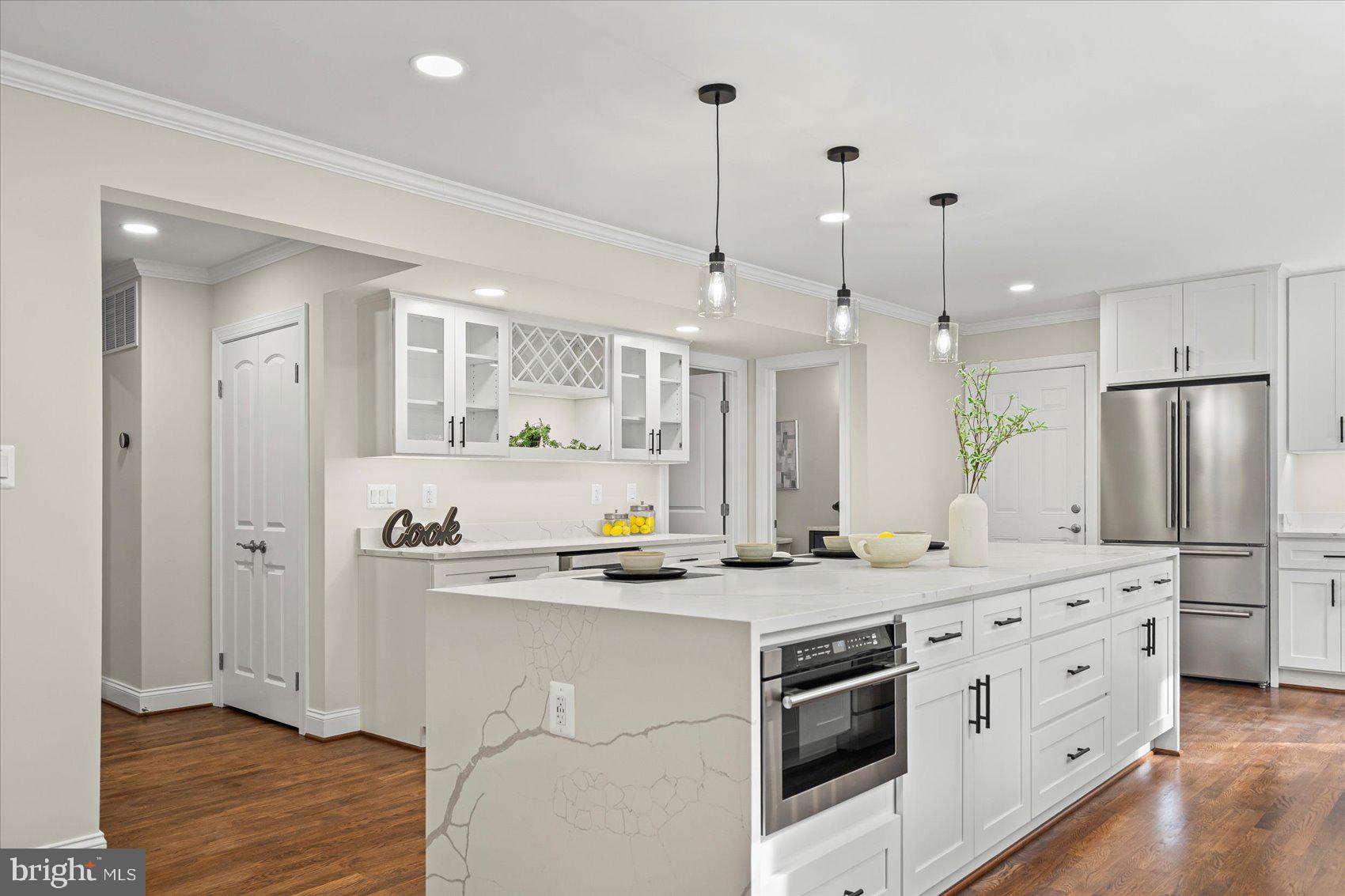 7604 Hackamore Drive Potomac, MD 20854 - Photo 19 of 81 a kitchen with stainless steel appliances granite countertop a sink a stove a refrigerator and island with wooden floor