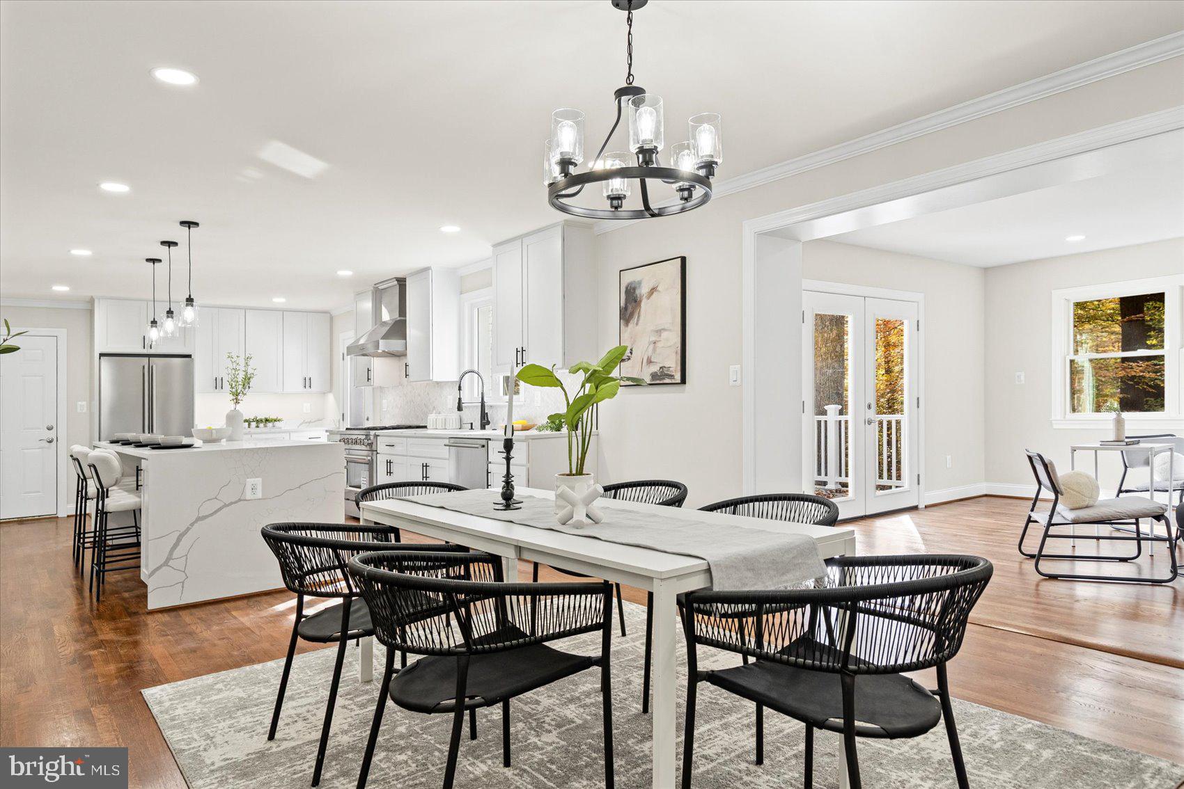 7604 Hackamore Drive Potomac, MD 20854 - Photo 24 of 81 a view of a dining room with furniture a chandelier and wooden floor