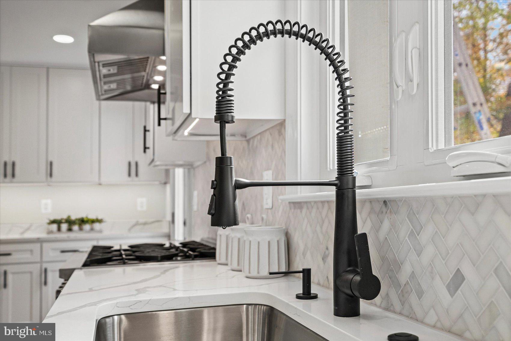 7604 Hackamore Drive Potomac, MD 20854 - Photo 25 of 81 a kitchen with a sink and a stove top oven