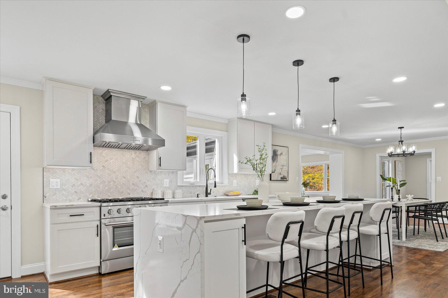 7604 Hackamore Drive Potomac, MD 20854 - Photo 30 of 81 a kitchen with stainless steel appliances granite countertop a kitchen island a stove a sink a dining table and chairs