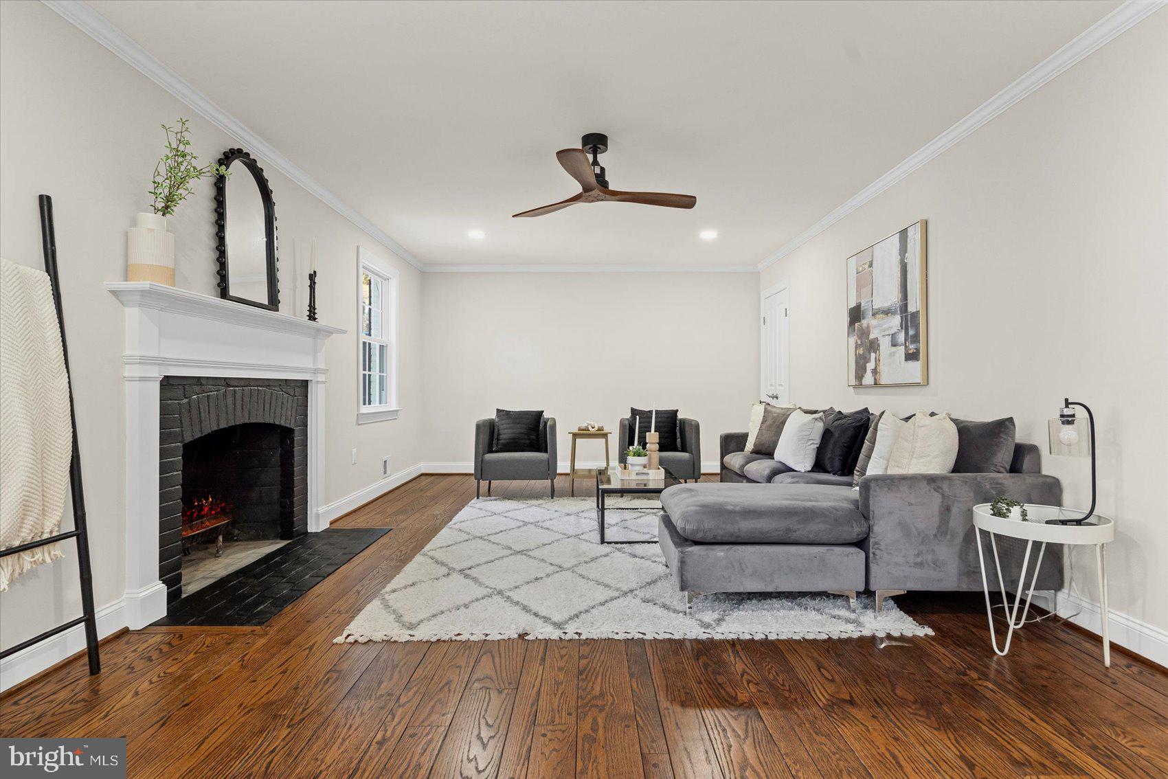 7604 Hackamore Drive Potomac, MD 20854 - Photo 35 of 81 a living room with furniture and a fireplace