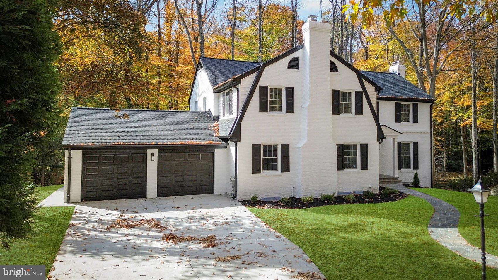 7604 Hackamore Drive Potomac, MD 20854 - Photo 4 of 81 a front view of a house with a yard and garage