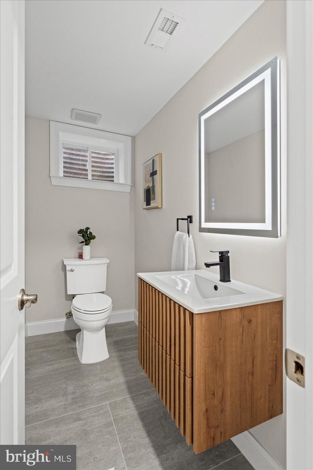 7604 Hackamore Drive Potomac, MD 20854 - Photo 44 of 81 a bathroom with a sink toilet and a mirror