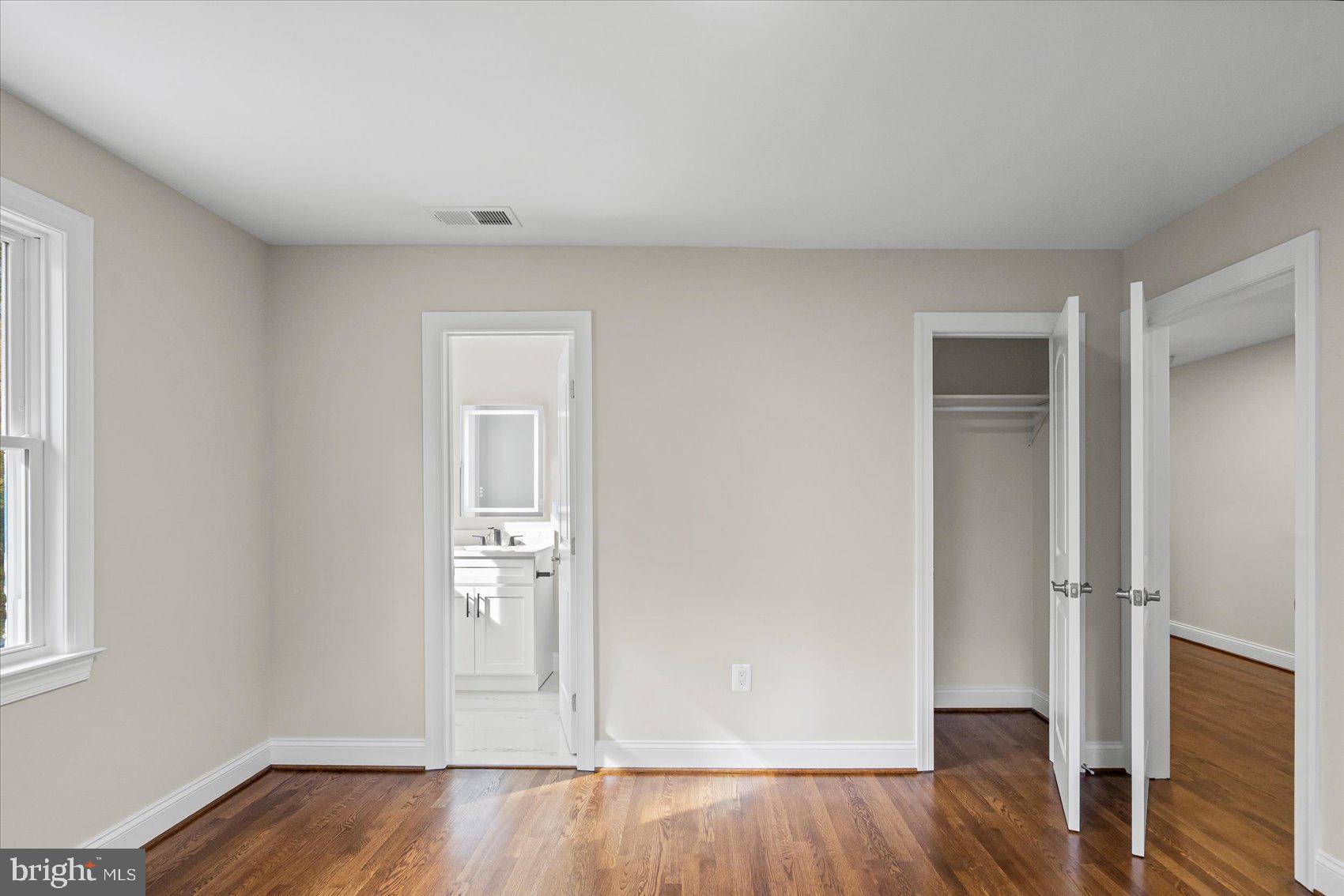 7604 Hackamore Drive Potomac, MD 20854 - Photo 53 of 81 an empty room with wooden floor and windows
