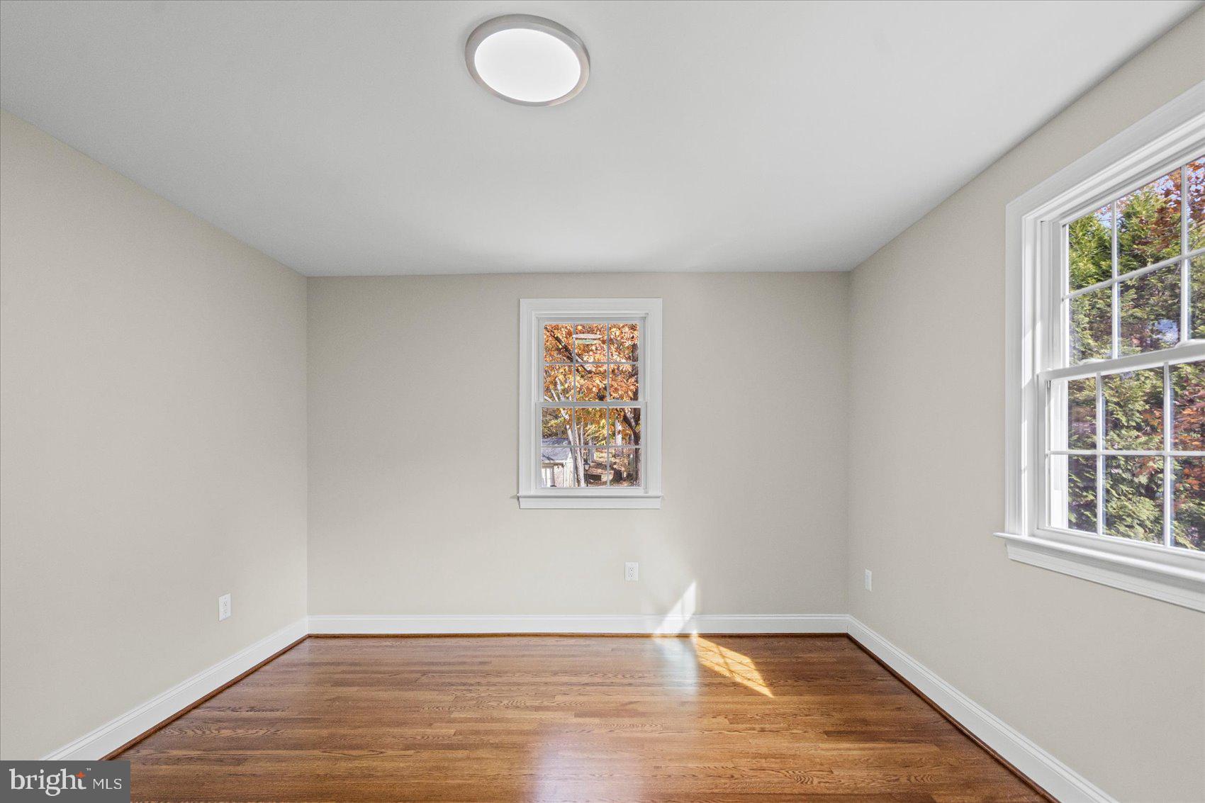 7604 Hackamore Drive Potomac, MD 20854 - Photo 56 of 81 an empty room with wooden floor and windows