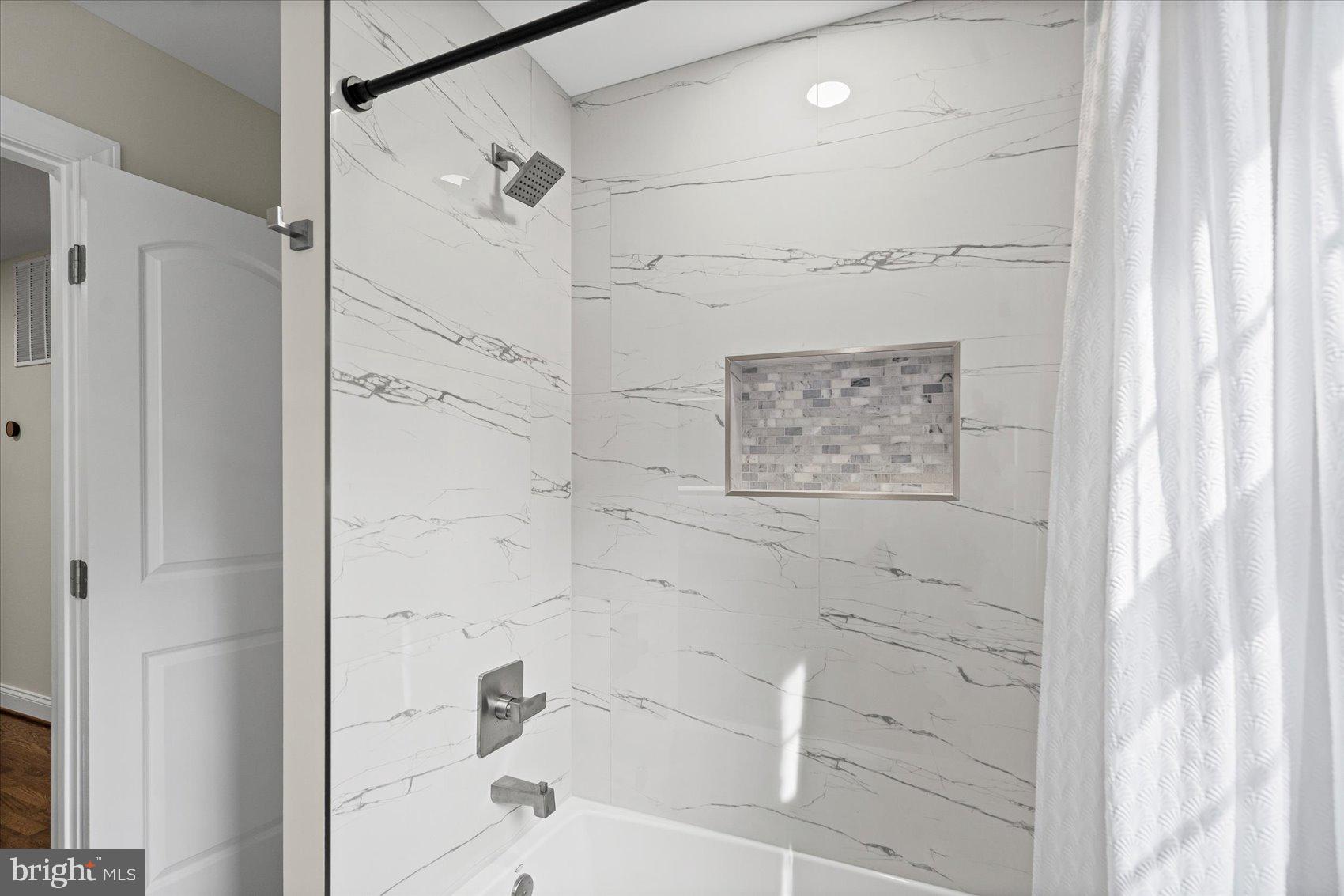 7604 Hackamore Drive Potomac, MD 20854 - Photo 59 of 81 a bathroom with a bathtub and shower