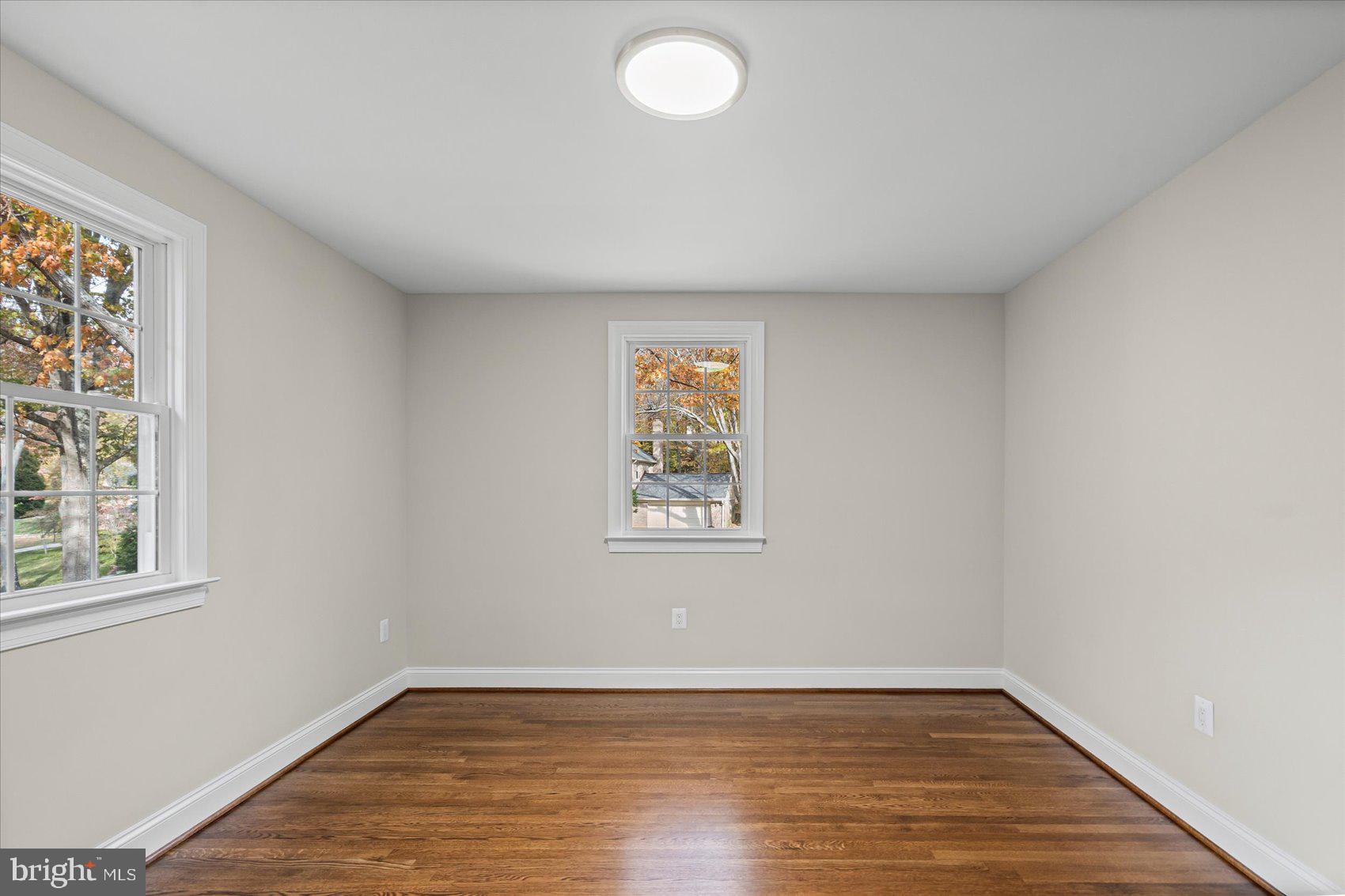 7604 Hackamore Drive Potomac, MD 20854 - Photo 61 of 81 an empty room with wooden floor and windows