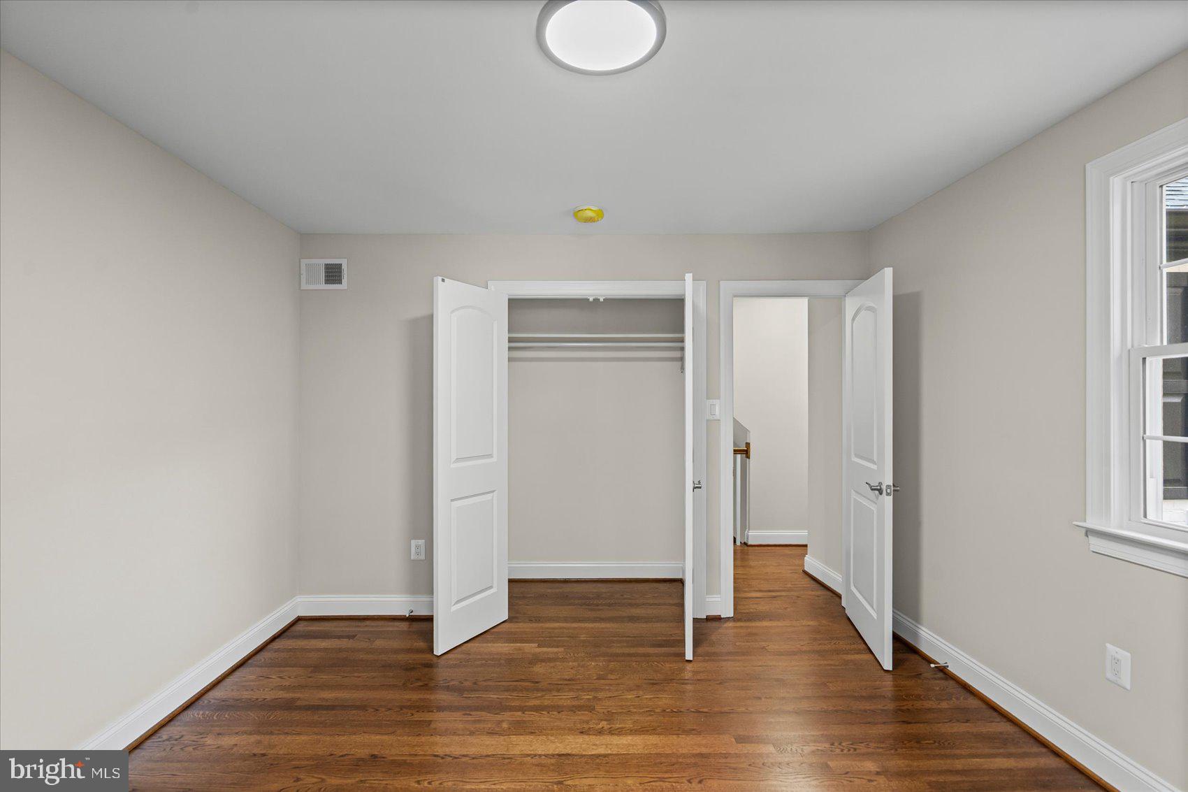 7604 Hackamore Drive Potomac, MD 20854 - Photo 62 of 81 a view of an empty room with wooden floor and a window