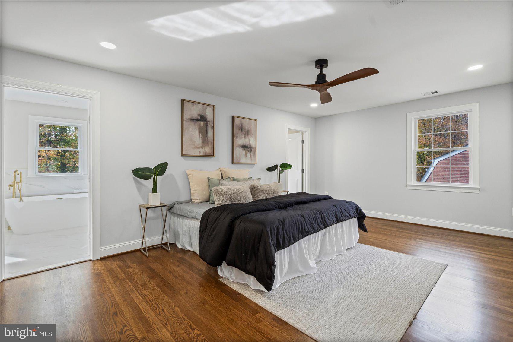 7604 Hackamore Drive Potomac, MD 20854 - Photo 63 of 81 a spacious bedroom with a bed a window and painting on the wall