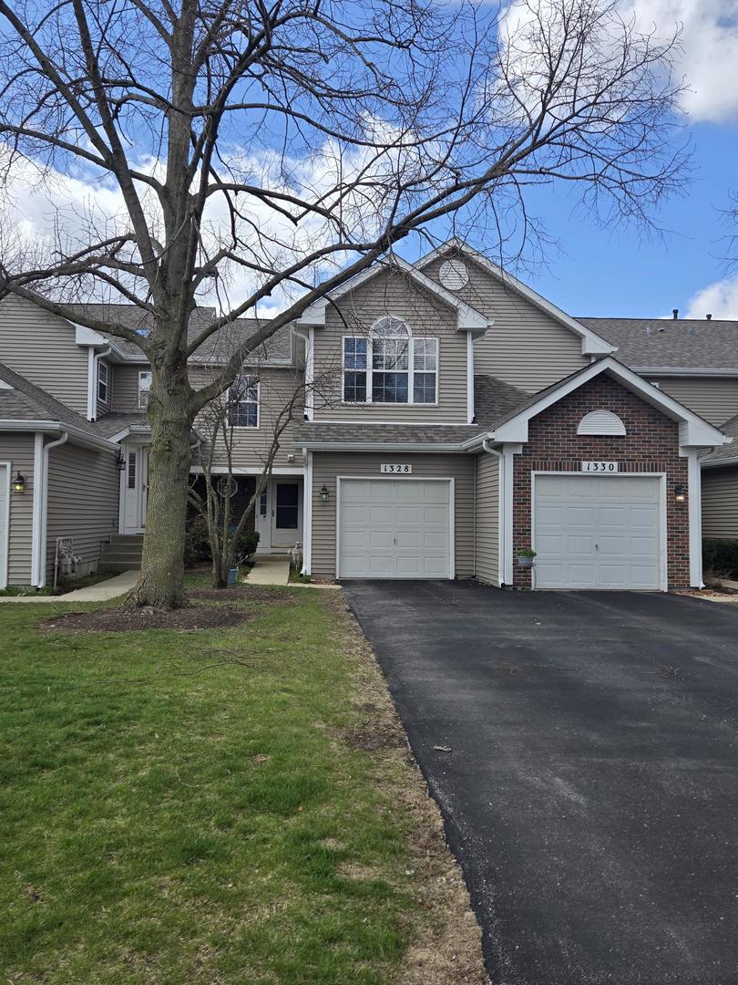 a front view of a house with a garden and yard