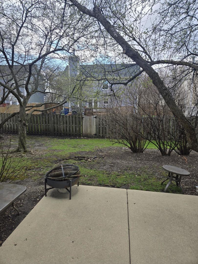 1328 Shawford Way Elgin, IL 60120 - Photo 18 of 19 a view of a backyard with plants and large trees