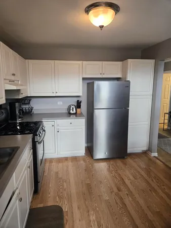 a kitchen with a refrigerator a sink and a stove