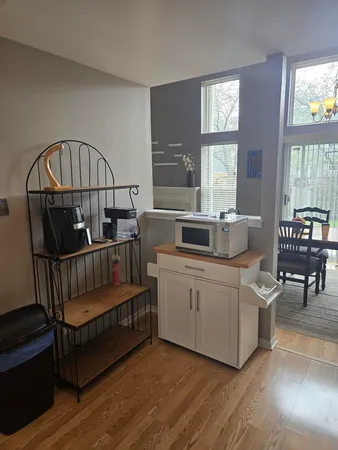 a living room with furniture stairs and a window