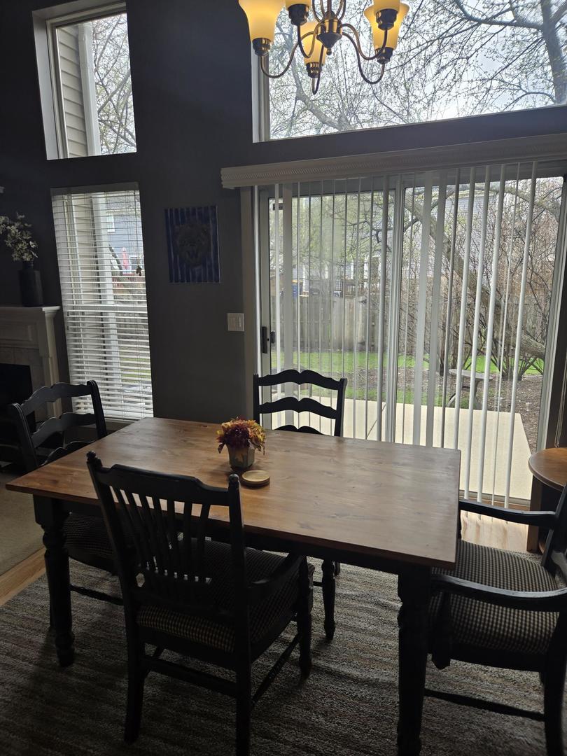 1328 Shawford Way Elgin, IL 60120 - Photo 9 of 19 a view of a dining room with furniture window and wooden floor