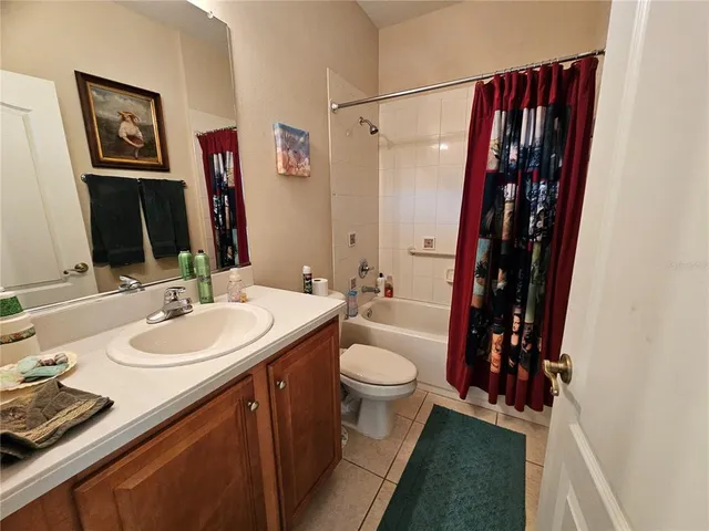 a view of a backyard with swimming pool and sitting area