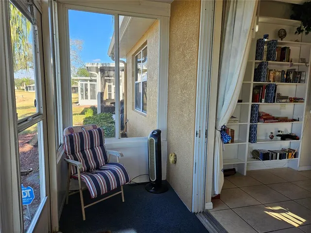 a living room with furniture and a book shelf