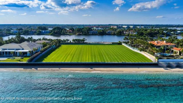 an aerial view of a swimming pool with lawn chairs and plants