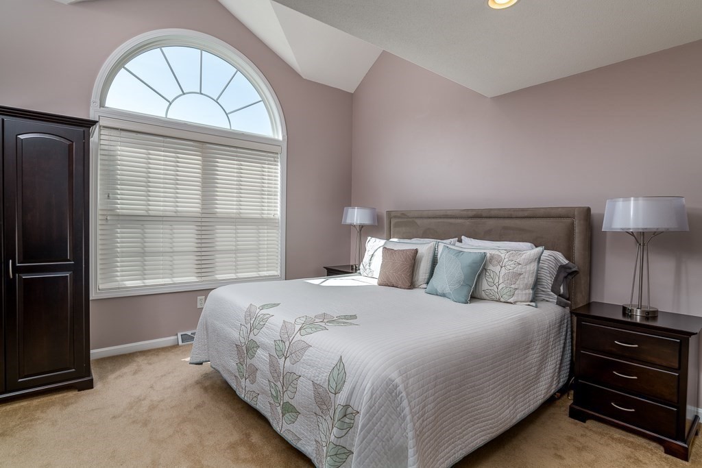 3 Michael Drive, Unit 3 Thorndike, MA 01079 - Photo 18 of 40 a bed room with a bed and a chandelier