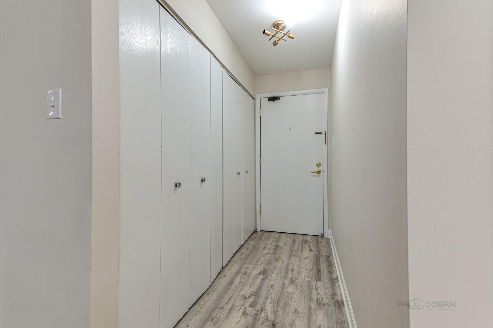 675 Grove Terrace, Unit 311 Elk Grove Village, IL 60007 - Photo 4 of 14 a view of a hallway with wooden floor