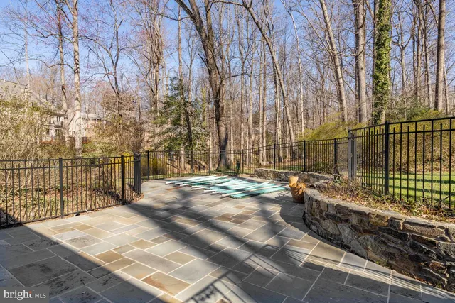 a view of a pathway with a wrought fence