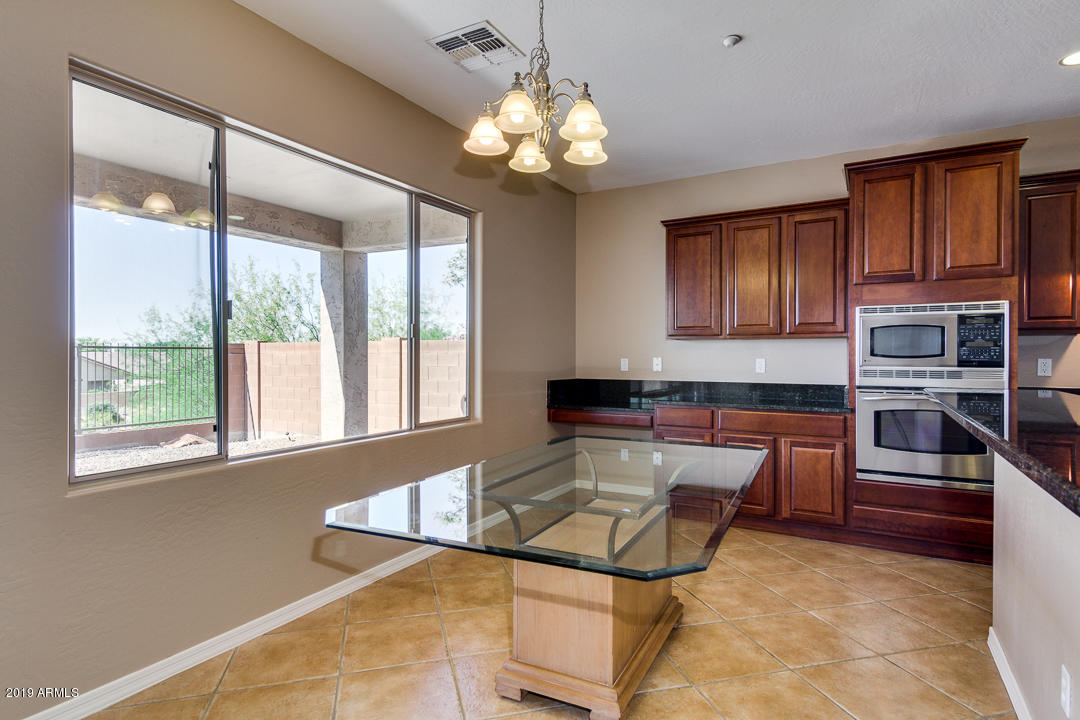 9121 West Plum Road Peoria, AZ 85383 - Photo 20 of 69 a kitchen with stainless steel appliances granite countertop a sink and cabinets