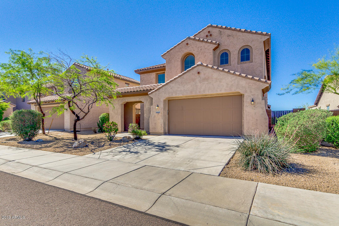 9121 West Plum Road Peoria, AZ 85383 - Photo 2 of 69 a view of a white house with potted plants
