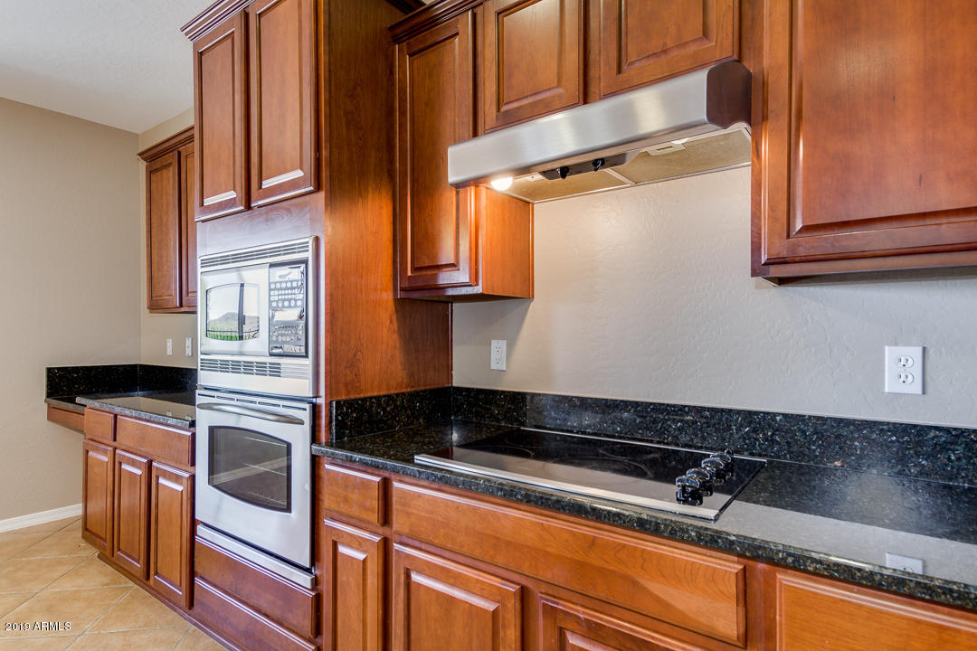 9121 West Plum Road Peoria, AZ 85383 - Photo 21 of 69 a kitchen with stainless steel appliances granite countertop a sink and cabinets