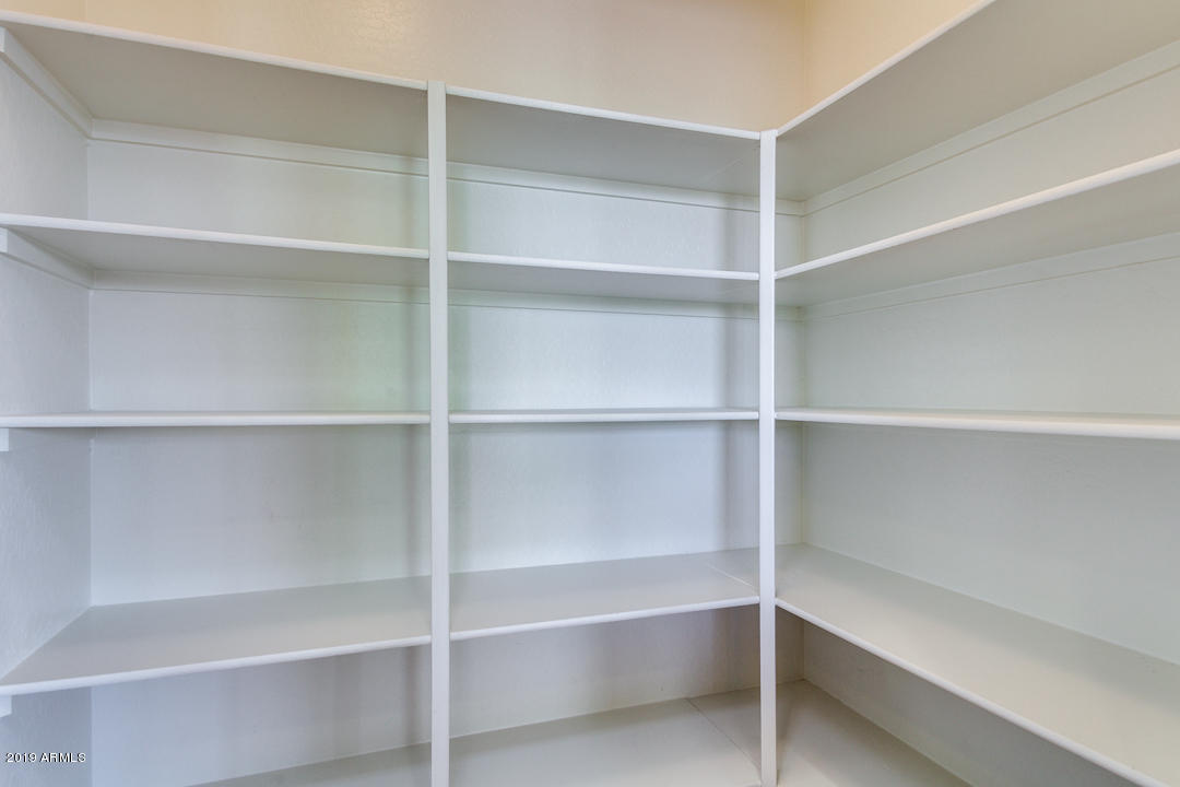 9121 West Plum Road Peoria, AZ 85383 - Photo 27 of 69 a view of walk in closet with empty racks