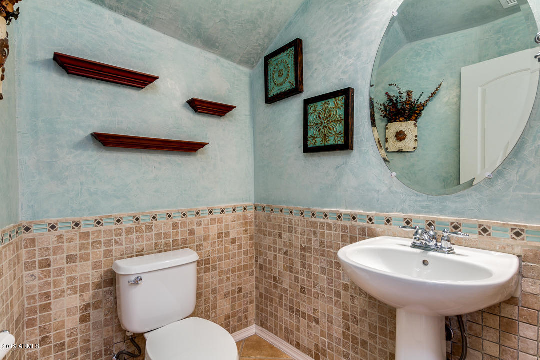 9121 West Plum Road Peoria, AZ 85383 - Photo 28 of 69 a bathroom with a toilet sink and mirror