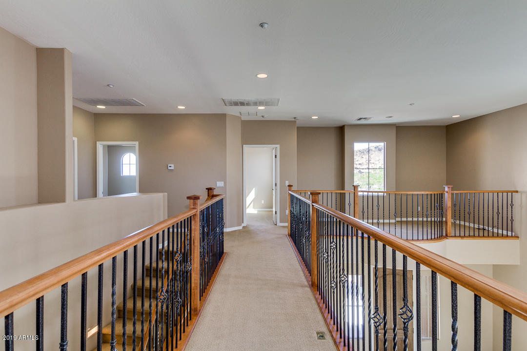 9121 West Plum Road Peoria, AZ 85383 - Photo 35 of 69 a view of a hallway with wooden floor