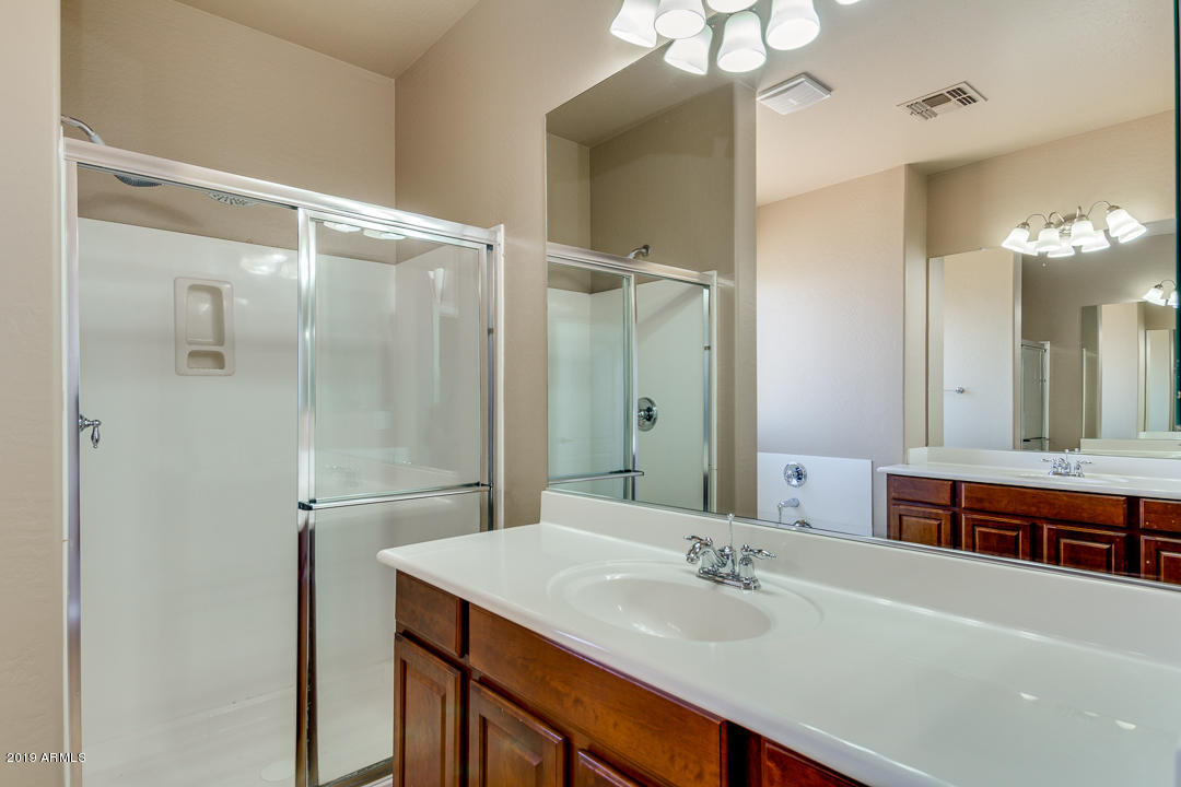 9121 West Plum Road Peoria, AZ 85383 - Photo 43 of 69 a bathroom with a sink and a mirror