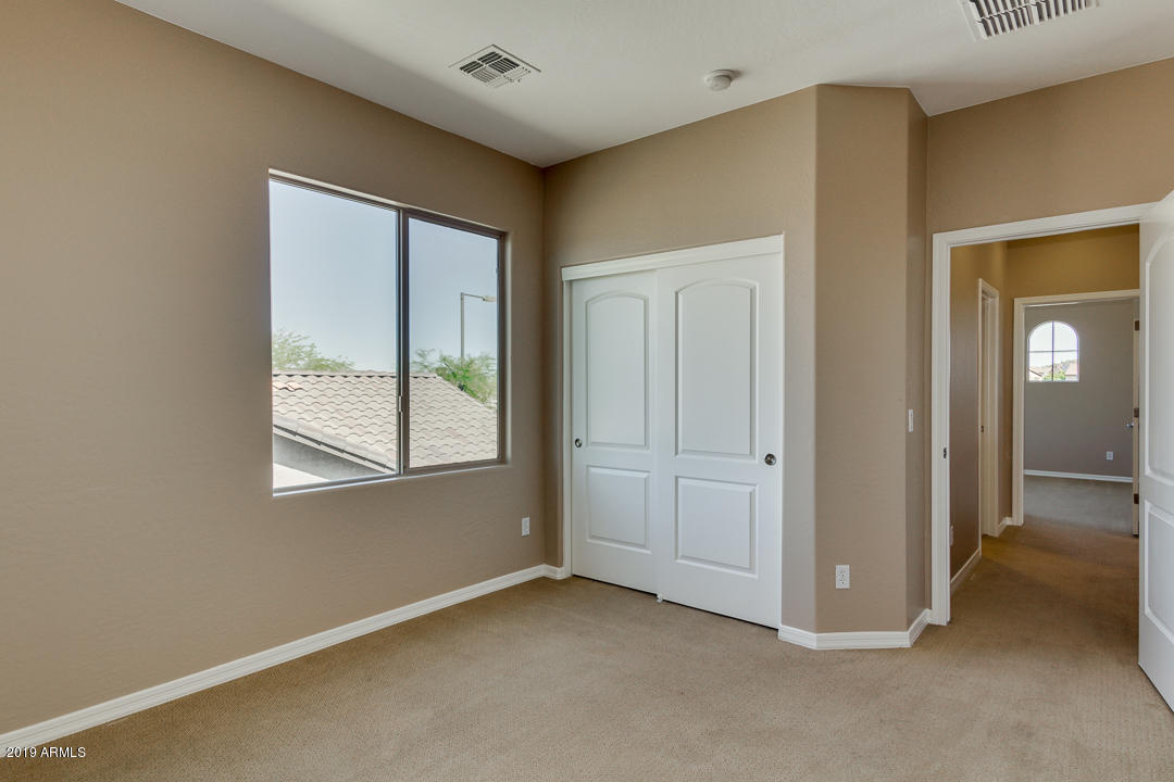 9121 West Plum Road Peoria, AZ 85383 - Photo 48 of 69 a view of an empty room with window and closet area