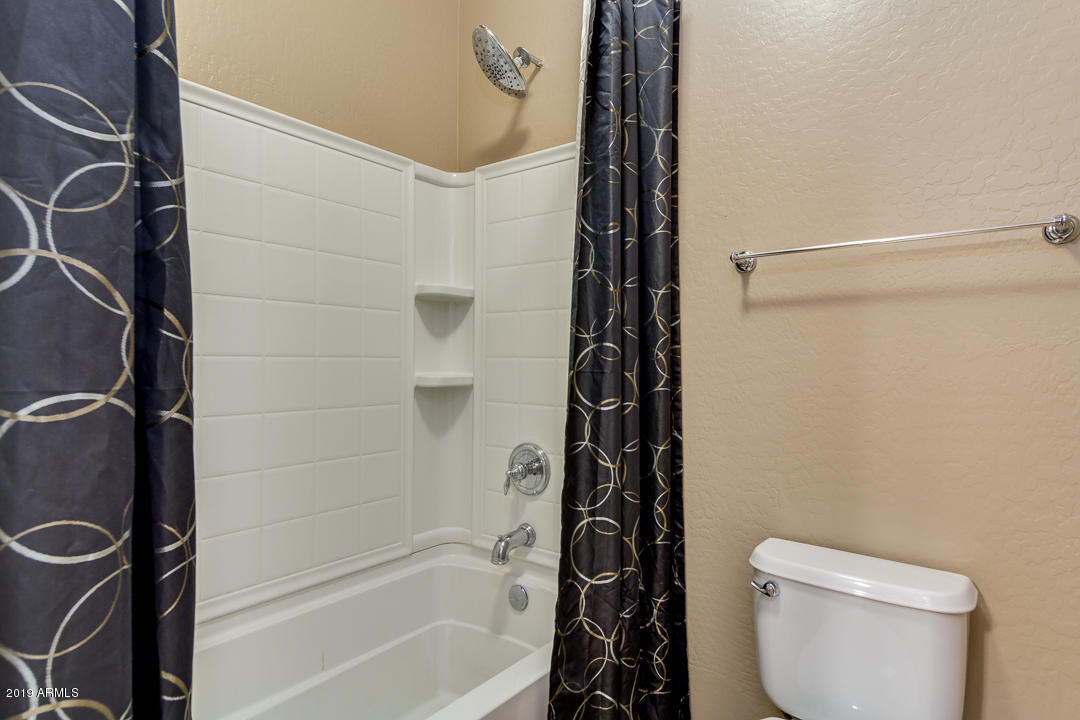 9121 West Plum Road Peoria, AZ 85383 - Photo 49 of 69 a bathroom with a toilet and a shower