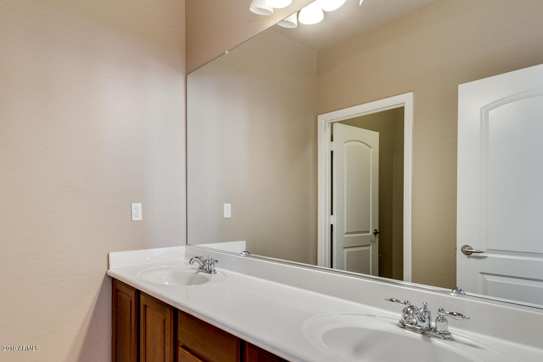 9121 West Plum Road Peoria, AZ 85383 - Photo 50 of 69 a bathroom with a sink and a mirror