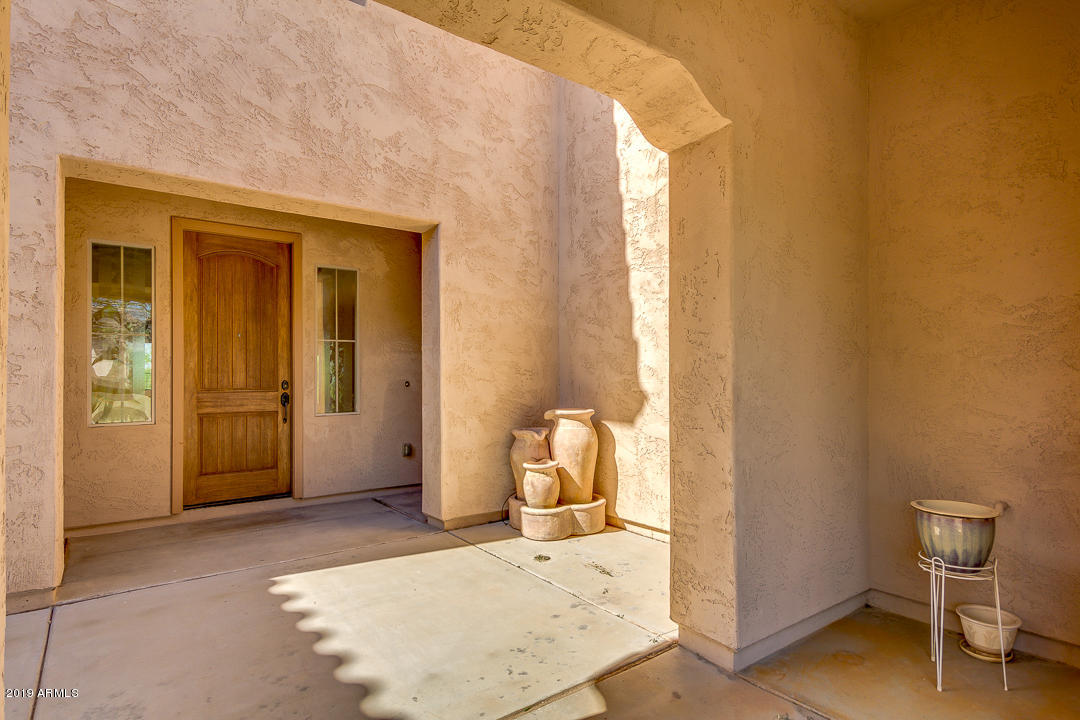 9121 West Plum Road Peoria, AZ 85383 - Photo 6 of 69 a view of an entryway with wooden floor