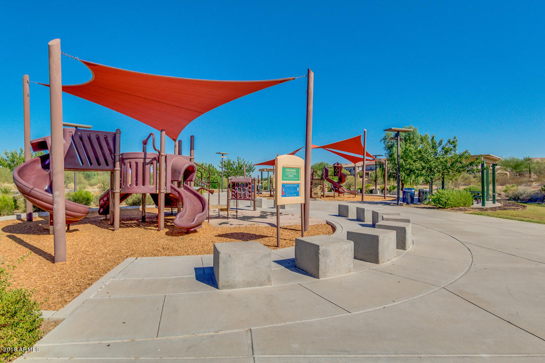 9121 West Plum Road Peoria, AZ 85383 - Photo 63 of 69 a view of a patio with dining table and chairs under an umbrella