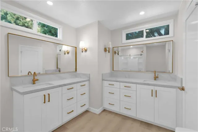 a bathroom with a granite countertop sink mirror and double