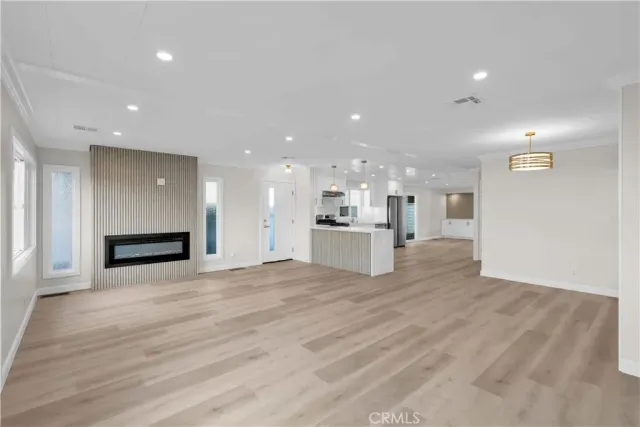 a view of kitchen with kitchen island and stainless steel appliances