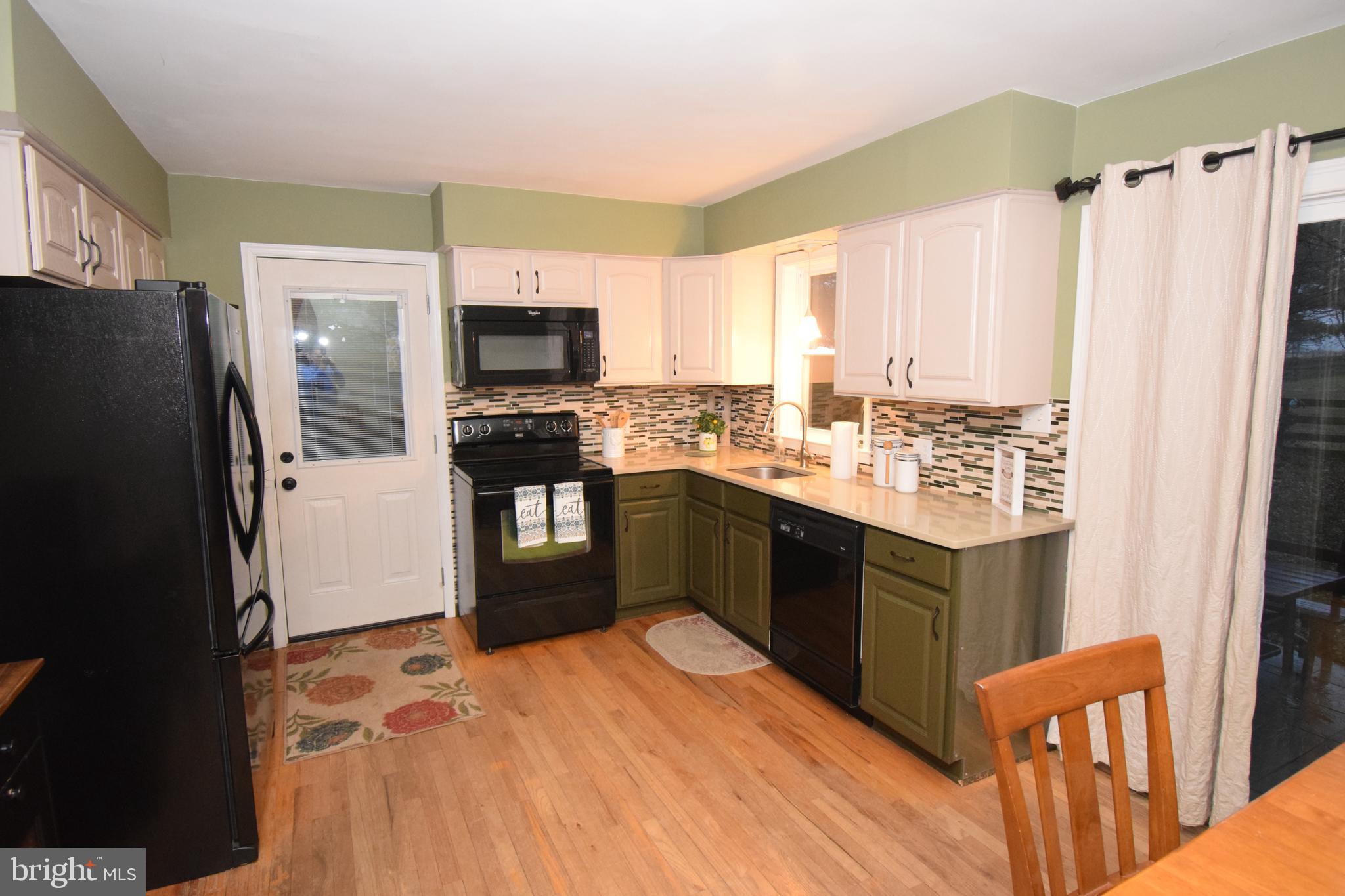 87 Half Mile Turn Rising Sun, MD 21911 - Photo 19 of 31 a kitchen with stainless steel appliances granite countertop a refrigerator a stove a sink dishwasher and a refrigerator