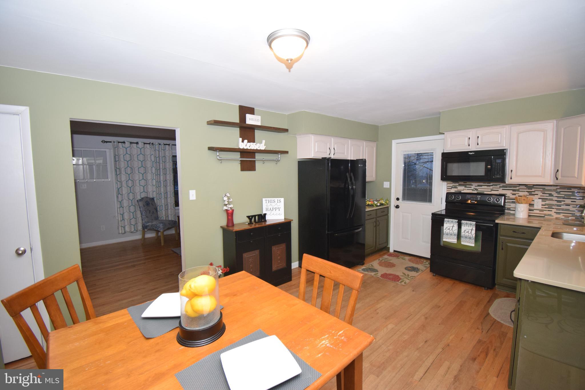 87 Half Mile Turn Rising Sun, MD 21911 - Photo 21 of 31 a kitchen with stainless steel appliances wooden floor dining table and chairs