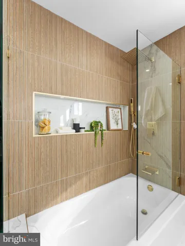 a bathroom with a bathtub and a shower