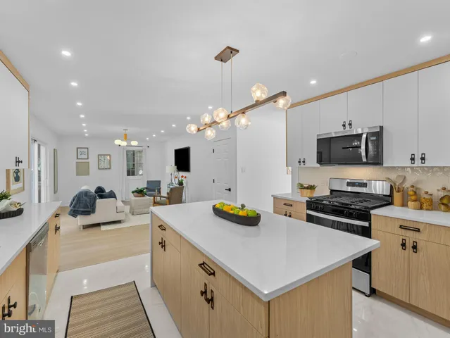 a kitchen with a sink a stove and chairs