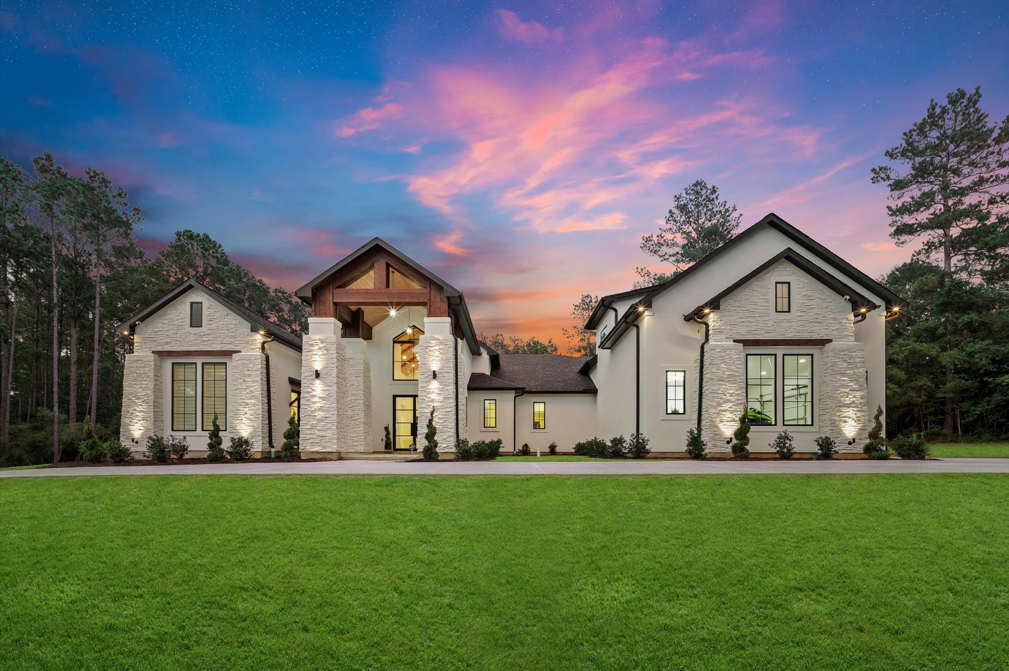437 Sundog Road Huntsville, TX 77340 - Photo 1 of 50 One-of-a-kind custom home situated on a private 2-acre corner lot in Texas Grand Ranch, surrounded by mature trees and designed with timeless architectural details.