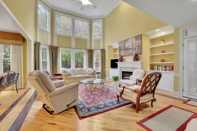 a kitchen with stainless steel appliances kitchen island granite countertop a table chairs in it and wooden floors