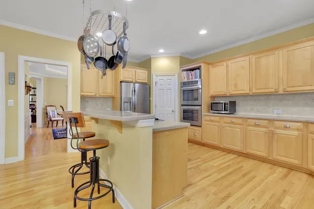 a large kitchen with stainless steel appliances granite countertop a stove and a sink