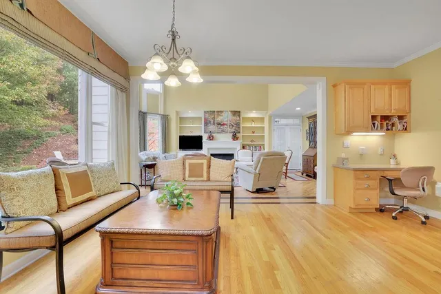 a living room with furniture and a floor to ceiling window