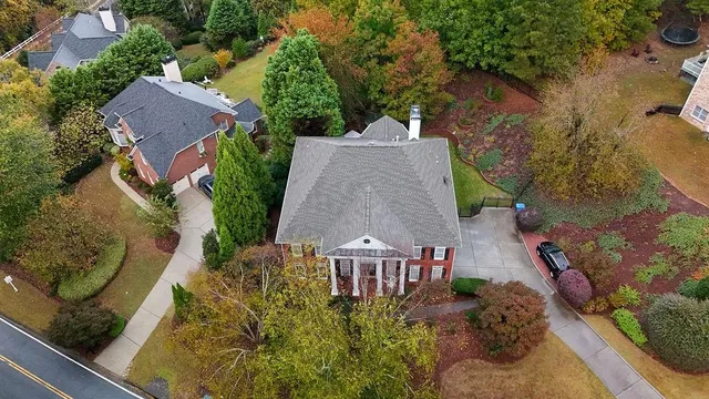 a front view of a multi story building with yard
