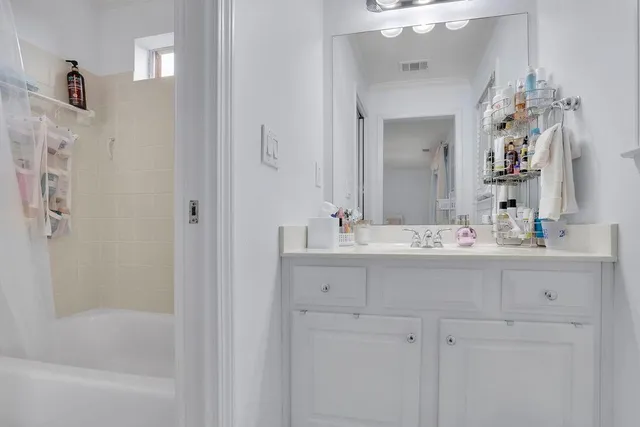 a bedroom with furniture and a rug