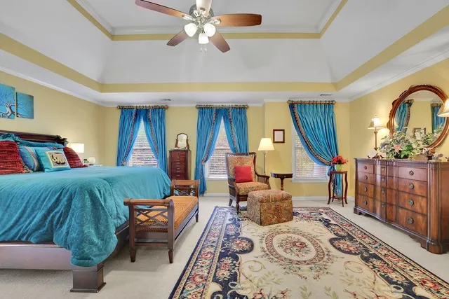 a bedroom with furniture and a flat screen tv