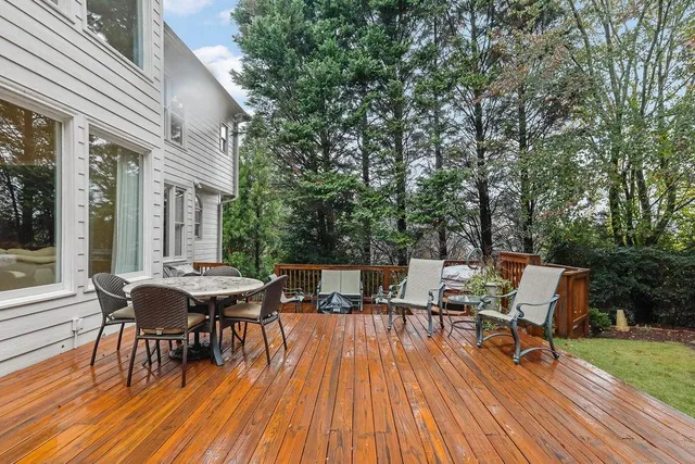 an aerial view of a house with a garden and lake view